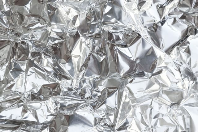 A sheet of crumpled aluminium foil filling the whole picture.