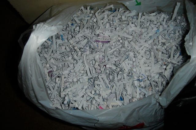 A large plastic sack full of shredded paper strips.