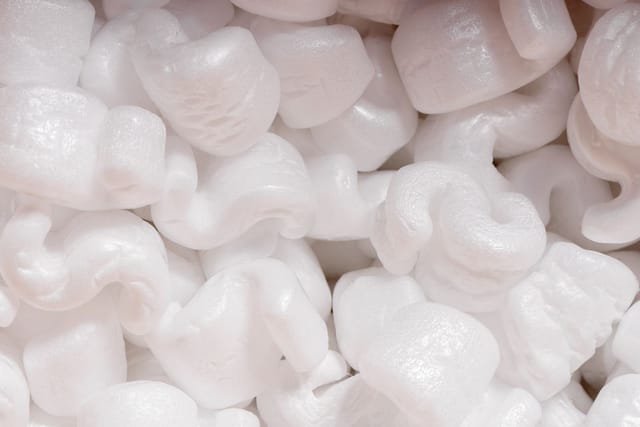 A mass of white polystyrene packing peanuts.